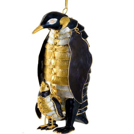 Hanging ornament in gold black and white. Shaped like a pinguin with a baby penguin standing on it's parents feet.