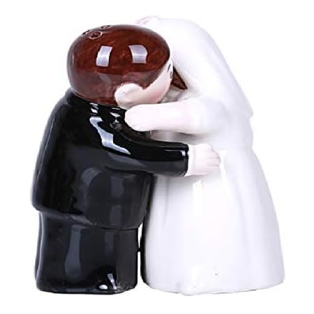 two salt and pepper shakers, shaped like a bride and a groom, they connect magnetically to look like they're hugging.