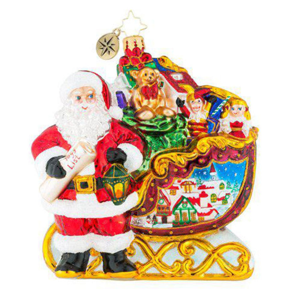 Radko Christmas ornament Santa Claus holding lantern in front of sleigh packed with gifts