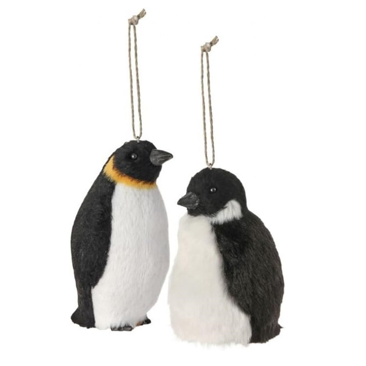 Two penguin ornaments hanging from strings on a white background