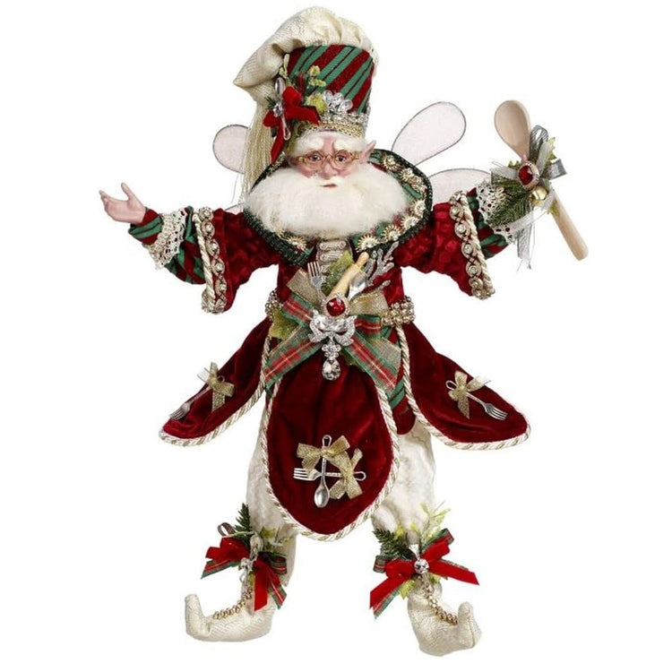 White bearded fairy with a festive red outfit with spoons on it.