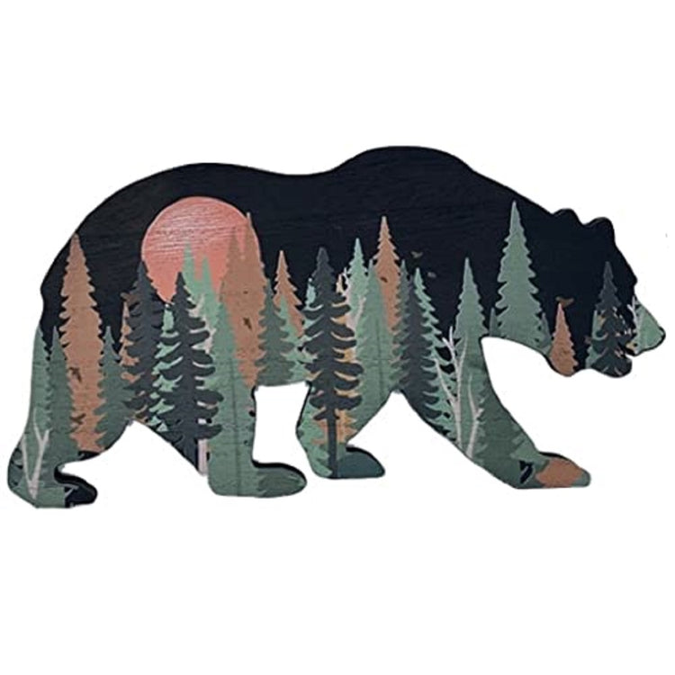 wall plaque in the shape of a bear with the bear black but a forest scene painted on the wood.