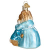 Back view of Glass ornament showing a mother bunny hugging their younger bunny.  Both rabbits are brown and wear blue, mom has a white apron. Glitter finish on edges.