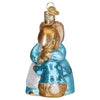 Side view of Glass ornament showing a mother bunny hugging their younger bunny.  Both rabbits are brown and wear blue, mom has a white apron. Glitter finish on edges.