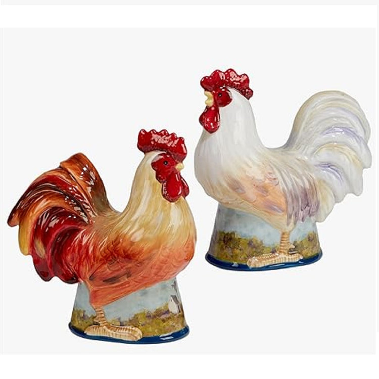 Rooster salt and pepper shakers. One rooster is shades of white and one shades of tan. Both sit on a base with a painted meadow design.