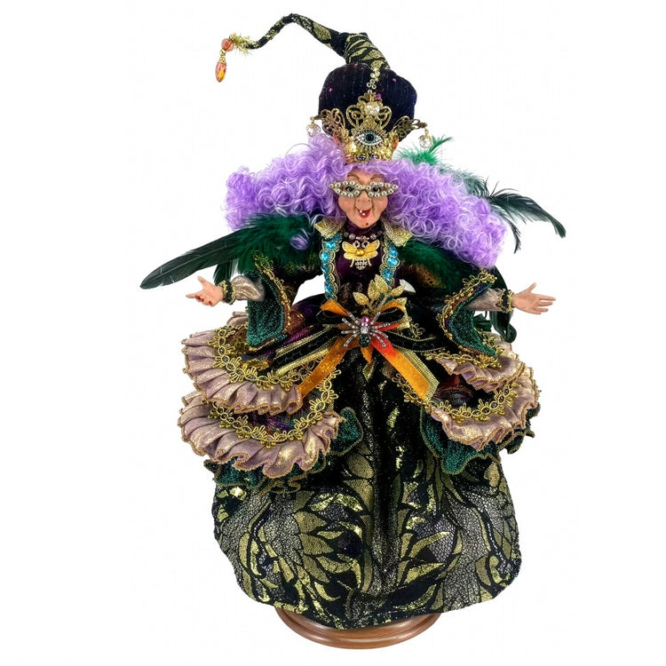 Decorative figurine with intricate costume and feathered headdress on a white background