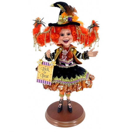 Halloween witch figurine with a large hat and 'Treat or Treat' sign on a white background