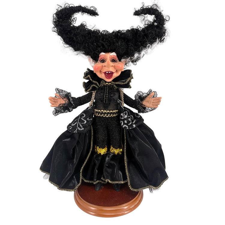 Figurine in a Frankenstein's bride inspired black costume with long hair on a white background