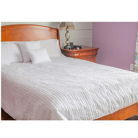 Bed with White Eyelash comforter, 2 matching shams and 2 matching pillows. Striped with short fringe or eyelash.
