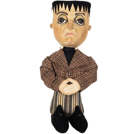 Figurine with resembelence of Frankenstsin with block head. brown plaid and striped suit, black boots.