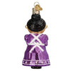 Back view of Mrs. Claus ornament wearing a long purple dress, white apron with black hair in a bun.