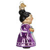 Side view of Mrs. Claus ornament wearing a long purple dress, white apron with black hair in a bun.