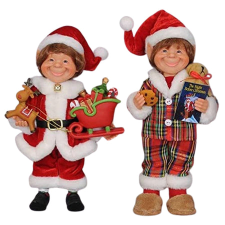 2 elf figures. One wears a traditional santa outfit and hat, carries a toy moose and sled with gifts. The other elf wears red and green plaid pajamas with white faux fir trim and santa hat. He carries a cookie and a Night Before Christmas book.