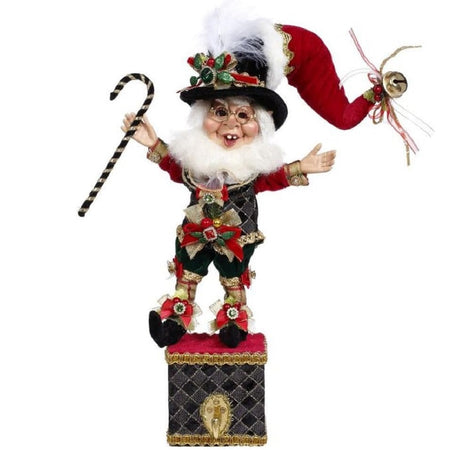 Elf holding a candy cane standing on a box that has a hook on the front.