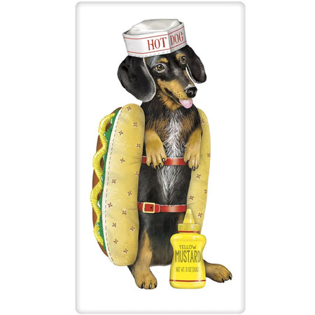 Dachshund dressed in a hot dog bun costume with a white hat that says hot dog and a plush bun sandwiched around the long body and a bottle of yellow mustard at his feet