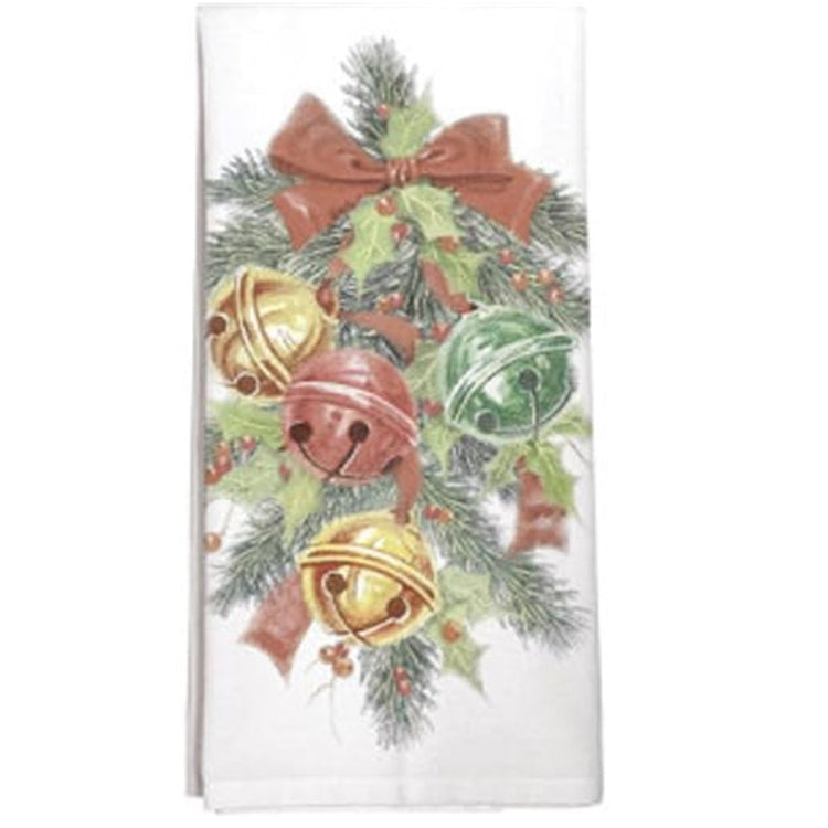 Folded white kitchen towel with pine branch swag and 4 jingle bells, 2 gold, 1 red and one green.  Holly accent and red bos.