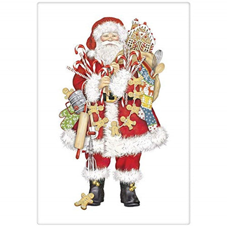 White kitchen towel with santa standing and holding a lot of items needed to make a gingerbread house.