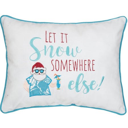 White rectangle pillow with teal piping and letters combined with red lettering. Shows a Santa figure in a red heat and tropical shirt. Text says Let it snow somewhere else!