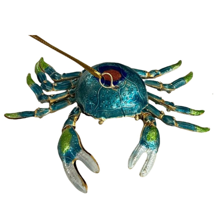cloisonne crab ornament made of copper with enamel, painted teal with a red and blue circle on top, tips of crabs legs are light green.