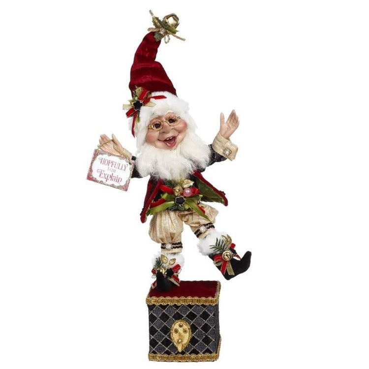 White bearded elf on a stocking holder box.