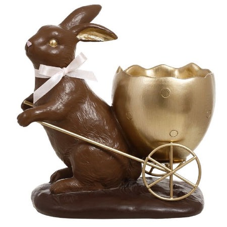 Chocolate rabbit with gold egg shaped cart. 