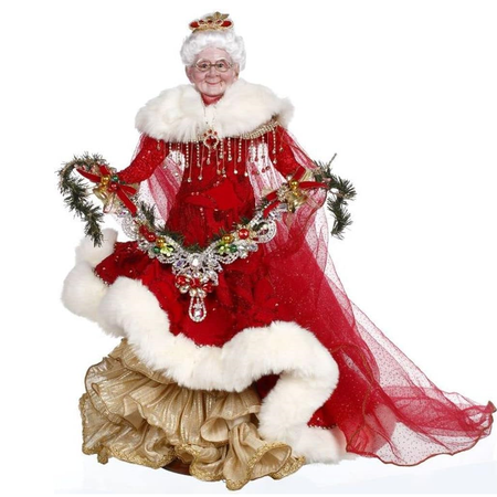mrs. claus in long red dress with white fur trim, a red train and holding a garland of jewels and pine.