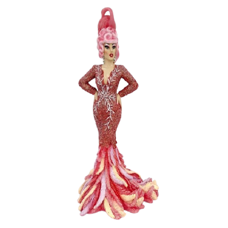 drag queen in pink longsleeve dress that ends in feathers of different shades of pink. Her hat is shaped like a flamingo.