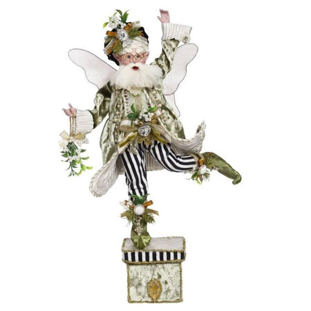 White bearded fairy holding mistletoe standing on a stocking holder.