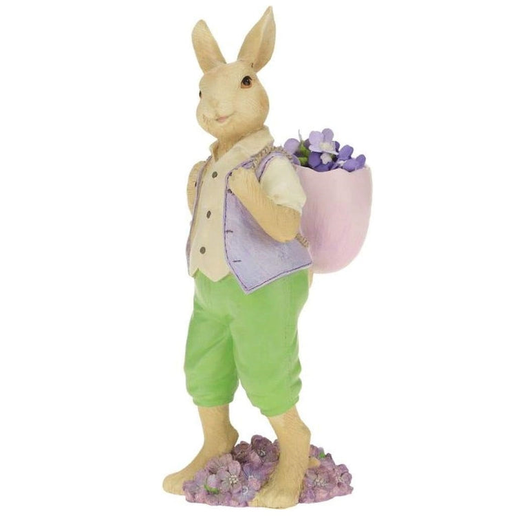 Tan rabbit with a vest & pants on & a basket full of flowers.