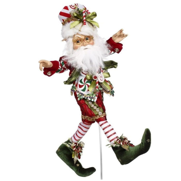 White bearded elf with a festive Christmas outfit & hat on.
