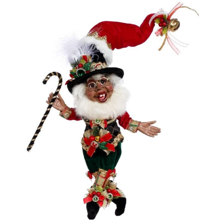 african american bearded elf wearing a black vest and dark green pants, with a santa hat stacked on top of a top hat and holding a black and gold cane.