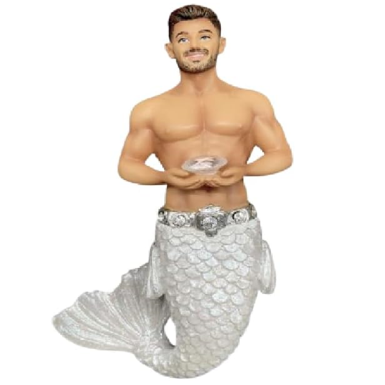 Merman figurine with a silvery white tail holding a diamond shaped gemstone on a white background