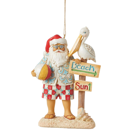 Decorative ornament of a beach-themed Santa Claus with a pelican and 'Beach Sun' sign on a white background.