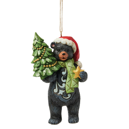Black bear in Santa Hat and Green Scarf, holding a small pine tree