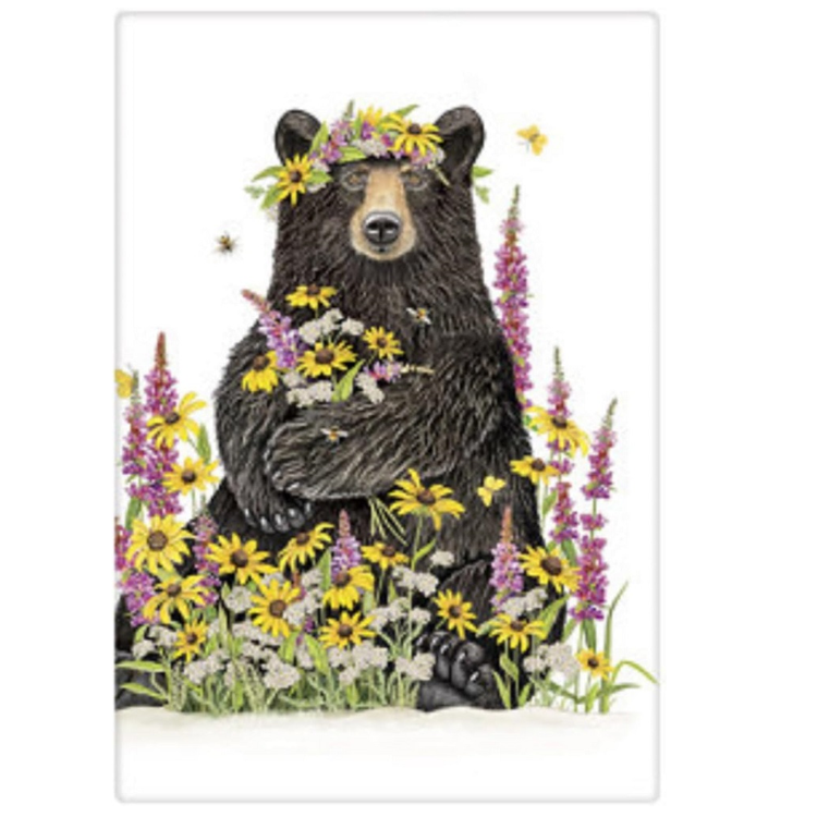 Image of a Black bear sitting in field of pink and yellow wild flowers, printed onto a white flour sack towel. 