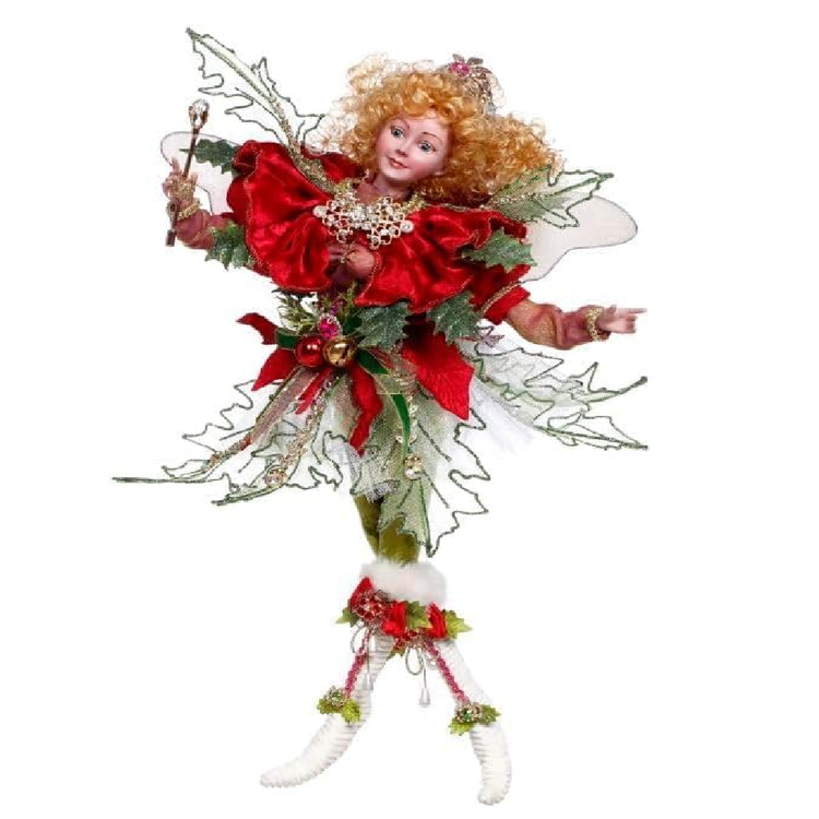 Decorative fairy figure with red and green attire on a white background