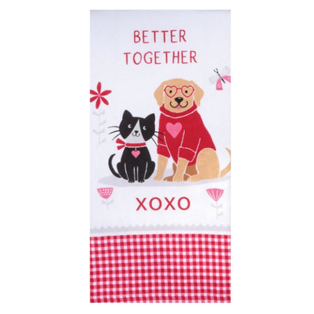 Folded white kitchen towel with a cat and dog. The dog wears heart shaped eyeglasses, the cat a heart colar. Dog has a heart sweater the print says Better Together XOXO and the bottom is red and white check.