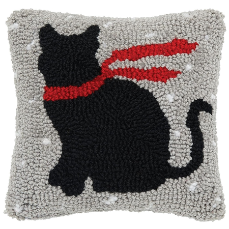 tan hooked rug pillow with black cat in a red scarf design.