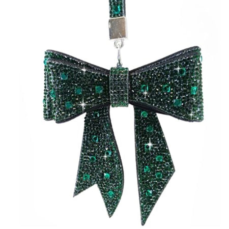 Green bow on a strap all encrusted with crystals, dark and light green, circular and square.