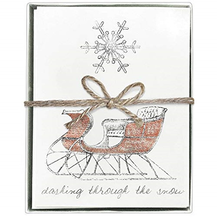 Boxed card set with a red sleigh and a snowflake. Dashing through the snow.