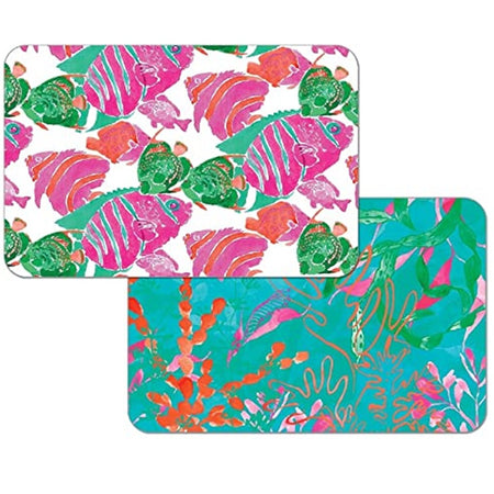 Photo shows both sides of a reversible placemat. One side has bright pink and green troical fish and the reverse side is an underwater coral and sea life scene in coordinating colors