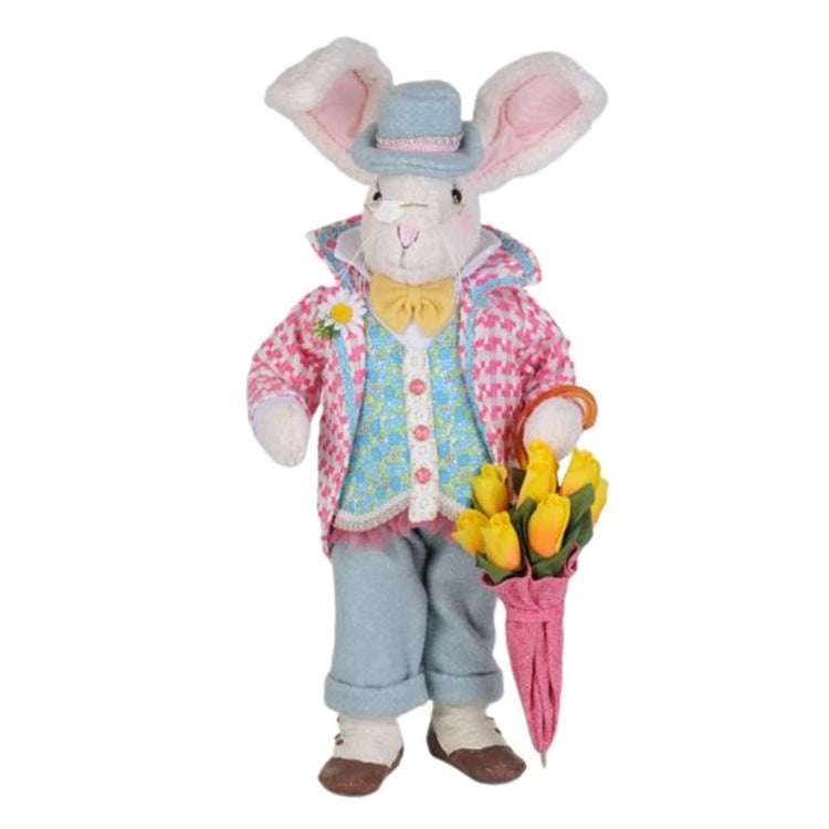 Standing bunny figurine. Dressed in pants, vest and jacket with hat in pastel coordinating colors of punk and blue.  He carries an umbrella that is stuffed with yellow flowers.
