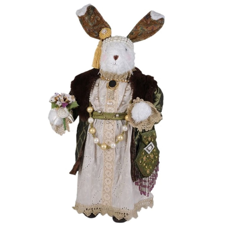 Standing bunny figurine. Elegantly dressed in a lace dress, beaded necklace and green jacket with fur trim. She wears a beaded head band and has floral ears with white fur. Holding a bunch of flowers.