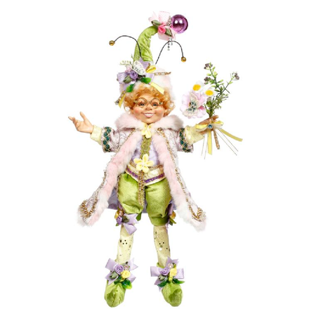 Elfin figurine wearing green shorts, a pink furry jacket, a green hat with ribbons and antennae, and holding a small bouquet of flowers.