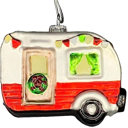 Pull behind camper design ornament in red and white. Pained holiday lights, green curtains and a wreath on the door.