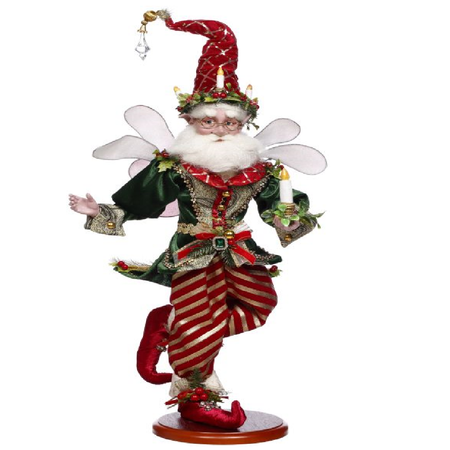 bearded fairy in gold and red pants, green jacket and holding a candle.