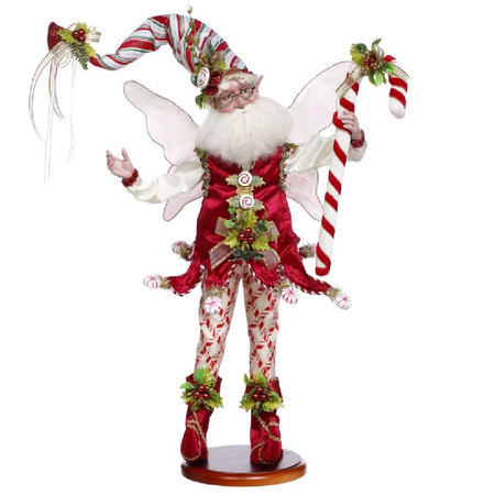 Bearded fairy in red outfit with peppermint and candy cane accents. holding a large candy cane.