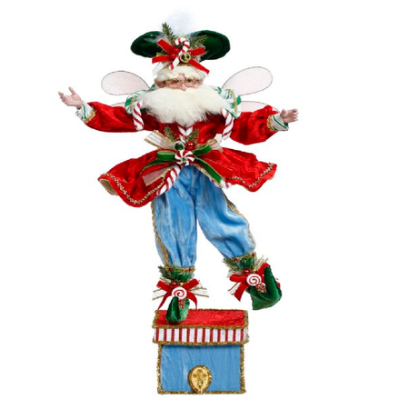 Bearded fairy figurine in red jacket and blue pants, on a blue box with a hook for a stocking.