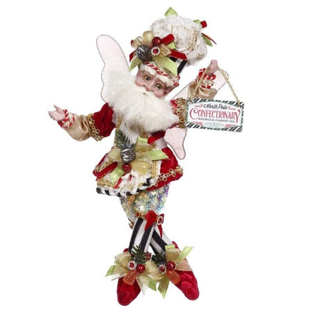 bearded fairy in red coat, black and white striped pants and holding a sign that says "North Pole Confectionary"