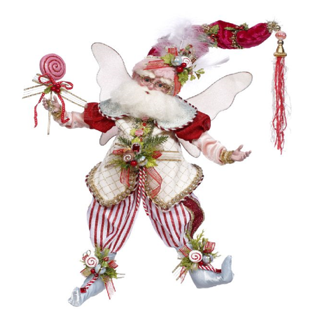 Decorative fairy figure in Christmas-themed outfit with candy and tassel on a white background